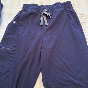 Four pairs of FIGS small and tall. Three are straight leg and one is jogger.